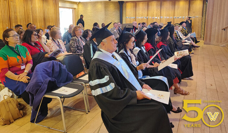 Graduands and audience watching events unfold