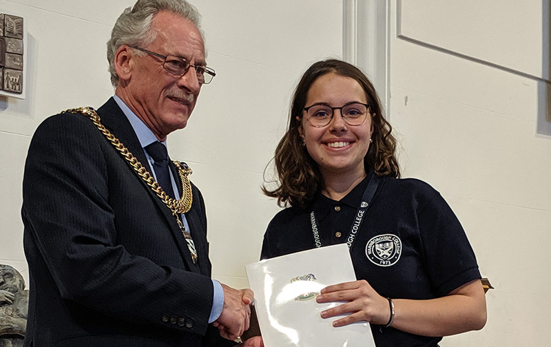 Catherine receives her certificate from the Mayor
