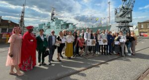 KArtsCon2024 delegates posing in front of the HMS Cavalier